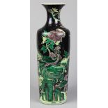 Chinese famille noir porcelain vase, the tall tapering body featuring a pair of phoenix amid large