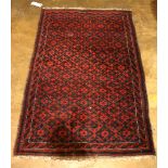 (lot of 2) Carpet group, consisting of a Balouch carpet, 4'6" x 2'8" together with a Persian