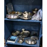 Two shelves of silver plate table articles and flatware, consisting of trays, bowls, lidded servers,