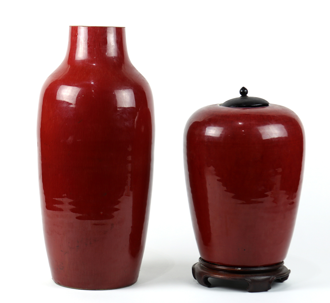 (lot of 2) Chinese ox blood glazed porcelain: first a tapering ovoid jar, with wood lid and stand;