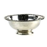 Webster Co. sterling silver serving bowl, having a vertical repousse stylized foliate rim, the