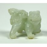 Chinese jade carving, of a fu-lion cub perched on the back of its parent, executed from a pale