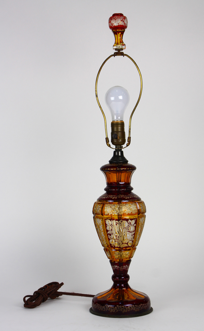 Bohemian style amber glass etched table lamp, having a single light, above a tapered form,
