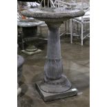 Classical style cast bird bath, having a circular bowl, above a baluster standard, and rising on a