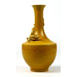 Chinese yellow glazed porcelain vase, with trumpet neck entwined with a stylized dragon in relief on