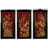 (lot of 3) Chinese carved wood panels, with birds and flowers of the seasons heightened in gilt on a