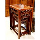 Set of four Chinese nesting tables, each with a floating top panel, the apron reticulated with