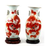 Pair of Chinese porcelain vases, featuring red lion and cubs, reversed by colophon bearing