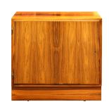 Danish Modern Poul Hundevad single door cabinet, having a highly figured case and rising on a molded