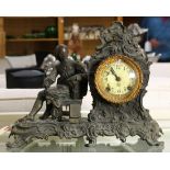 Ansonia figural mantle clock, having a patinated metal case, the dial with Arabic markers, and