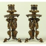 Pair of Russian partial gilt silver candlesticks, each with garland swags and rams head mounts