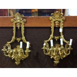 Pair of gilt bronze electrified candelabrum wall sconces, each having four lights suspended from the