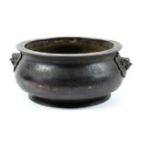 Chinese bronze censer, with an everted rim and low slung body flanked by lion-form handles, base