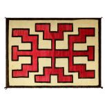 Navajo Ganado rug, early 20th century, having a geometric design in red and brown, on a cream ground