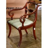 Regency mahogany armchair, having a partial gilt splat centering the inswept arms, and rising on