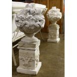 Pair of outdoor cement garden elements depicting baskets of flowers above the square pedestals,