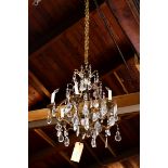 Neo-Classical patinated metal six-light chandelier, accented throughout with prisms, 23"h