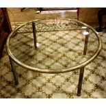 Hollywood Regency style cocktail table, having a circular plate glass top, above tubular legs, 18"