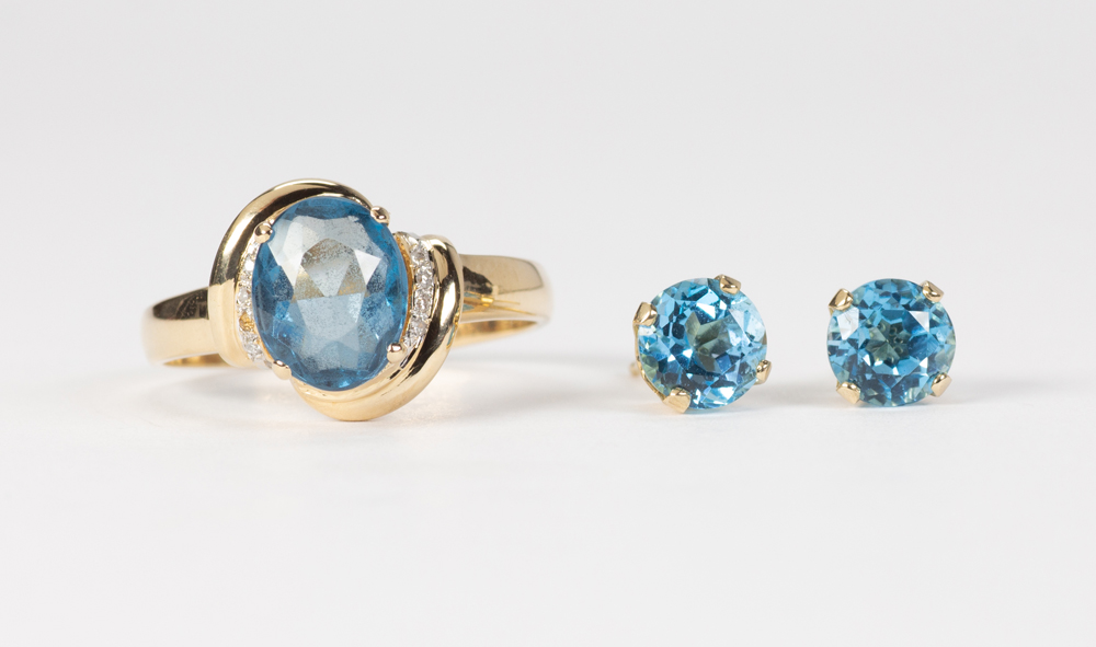 Blue topaz and 14k yellow gold jewelry suite Including 1) oval-cut blue topaz, accented by (7)