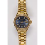 Lady's diamond and gold wristwatch Dial: round, blue, applied diamond hour markers, outer gold baton