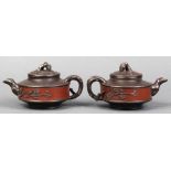 Pair of Chinese zisha teapots, the caramel hue body applied with flowering branches of chocolate