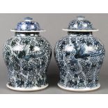 Pair of Chinese underglaze blue porcelain lidded jars, each with phoenix amid dense floral sprigs,