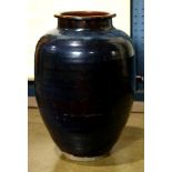 Chinese glazed ceramic storage jar, with a blue-black glaze to the ribbed oviod form, over the