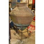 Large antique French terra cotta amphora, rising on a later wrought iron stand, overall 50"h x 36"w