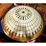 Arts and Crafts style leaded glass pendant lamp, having a dome form with carmel, cream and green