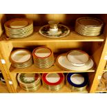 Three shelves of assembled Lenox porcelain, all with gilt rims, consisting of dinner plates, salad
