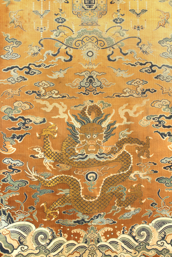 Chinese orange ground brocade silk chair cover, featuring a meandering gilt dragon, above a floral - Image 2 of 3