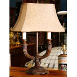 Patinated bouillotte style lamp, having two arms and rising on an oval base, 24"h x 16.5"w