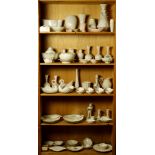 Five shelves of mostly Lenox including vases and serving dishes, each having a gilt rim on a cream