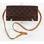 Louis Vuitton Twin GM shoulder bag, having a brown coated canvas monogram pattern with brass