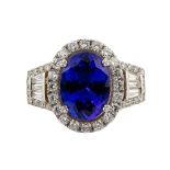 Tanzanite, diamond and 18k white gold ring Centering (1) oval-cut tanzanite, weighing