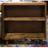 Mid Century bookstand, having two tiers and rising on tapered legs, 30"h x 30"w x 11"d