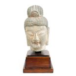 Chinese stone bodhisattva head, with traces of pigment accents, together with wood stand, head: 8.