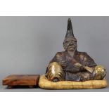 Japanese ceramic okimono, figure of seated Tokugawa Shogun, holding a letter in his left hand,