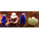Chinese four snuff bottles: two blue glass bottles, an aubergine overlaid white vessel with deer;