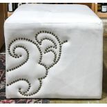 Hollywood Regency style ottoman, having a stylized brass nail head trim detail, 18"h x 22" square