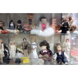 Four shelves of dolls, including Betty Boop, Raggedy Anne, and miscellaneous doll parts, the largest