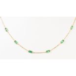 Emerald and 18k yellow gold necklace Composed of (12) emerald-cut emeralds, weighing a total of