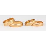 (Lot of 4) Yellow gold band rings Including 1) 4.0 mm, 14k yellow gold band, size 10.25; 2) 4.0