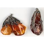(Lot of 2) Amber and silver pendants Including 1) amber and silver drop pendant, measuring