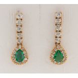 Pair of emerald, diamond and 14k yellow gold earrings Featuring (2) pear-cut emeralds, weighing a