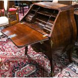Chippendale style mahogany bombe desk, having a slant front opening to a fitted interior,