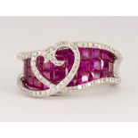 Diamond, ruby, 18k white gold heart ring Featuring (30) calibre-cut rubies, weighing a total of