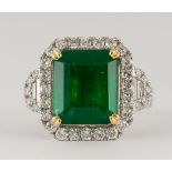Emerald, diamond and 18k white gold ring Centering (1) emerald-cut emerald, weighing 6.67 cts.,