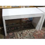 Modern white laquered work station, having two drawers centering the slab legs, 29"h x 48"w x 20"