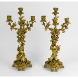 (lot of 2) Rococco style gilt bronze four arm candelabra, each having a tree form standard fronted